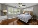 Comfortable bedroom featuring a ceiling fan, hardwood floors, and lots of natural light at 4106 Castlewood Rd, Charlotte, NC 28209