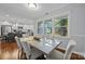 Dining area with modern table set, connecting to the kitchen and offering serene backyard views at 4106 Castlewood Rd, Charlotte, NC 28209