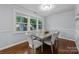 Elegant dining room filled with natural light, features a glass-top table and seating for six at 4106 Castlewood Rd, Charlotte, NC 28209