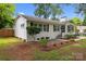 Well-maintained white brick home with updated landscaping and a charming, cozy curb appeal at 4106 Castlewood Rd, Charlotte, NC 28209