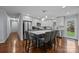 Open kitchen featuring white cabinets, stainless steel appliances, and a center island with bar seating at 4106 Castlewood Rd, Charlotte, NC 28209
