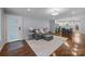 Inviting living room boasts hardwood floors, neutral paint, and seamless access to the kitchen and dining area at 4106 Castlewood Rd, Charlotte, NC 28209