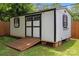 Exterior view of the shed featuring a ramp, black and white paint and an awning for the window at 4106 Castlewood Rd, Charlotte, NC 28209
