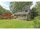 Charming home with a green lawn, brick patio, and mature trees in the backyard at 501 E Tremont Ave, Charlotte, NC 28203