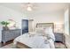 Cozy bedroom with floral bedding, gray furnishings, a ceiling fan, and shuttered windows at 501 E Tremont Ave, Charlotte, NC 28203