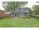 Quaint home featuring a well-maintained lawn and a brick patio with outdoor seating at 501 E Tremont Ave, Charlotte, NC 28203