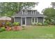 Charming home showcasing a well-manicured lawn and a brick patio with outdoor seating at 501 E Tremont Ave, Charlotte, NC 28203