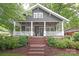 Charming home with a welcoming front porch, manicured landscaping, and classic details at 501 E Tremont Ave, Charlotte, NC 28203