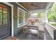 Charming front porch with a wooden dining table, benches, and covered ceiling at 501 E Tremont Ave, Charlotte, NC 28203