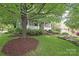 Beautiful home with mature tree in the front yard, lush lawn and greenery providing a serene and inviting atmosphere at 501 E Tremont Ave, Charlotte, NC 28203
