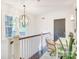 Hallway with a decorative light fixture, desk, chair, and green plant at 501 E Tremont Ave, Charlotte, NC 28203