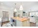 Bright kitchen featuring a butcher block island, stainless steel appliances, and an open layout leading to the living area at 501 E Tremont Ave, Charlotte, NC 28203