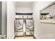 Modern laundry room featuring updated washer and dryer units, open shelving, and decorative accents, creating a functional space at 501 E Tremont Ave, Charlotte, NC 28203