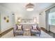 Spacious main bedroom featuring two chairs, neutral decor, and bright windows at 501 E Tremont Ave, Charlotte, NC 28203