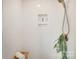 A modern, fully tiled white shower with a shampoo niche and overhead shower head at 501 E Tremont Ave, Charlotte, NC 28203
