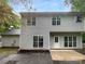 Backyard featuring a patio area surrounded by a green lawn and trees at 524 N Portman Ln, Fort Mill, SC 29708