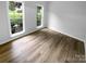 Clean bedroom with modern flooring and natural light from two windows at 524 N Portman Ln, Fort Mill, SC 29708