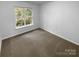Cozy bedroom with neutral carpet, window, and natural light at 524 N Portman Ln, Fort Mill, SC 29708