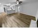 Open-concept living room with modern flooring, a ceiling fan, and view of the kitchen at 524 N Portman Ln, Fort Mill, SC 29708
