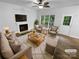 Bright living room featuring fireplace, plush seating, and natural light at 524 N Portman Ln, Fort Mill, SC 29708