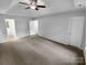 Spacious main bedroom with carpet, ceiling fan, and multiple doors at 524 N Portman Ln, Fort Mill, SC 29708