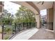 Spacious balcony with wrought iron railing and lush green view at 5425 Closeburn Rd # 208, Charlotte, NC 28210