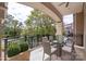 Elegant balcony with glass table, seating, and beautiful views at 5425 Closeburn Rd # 208, Charlotte, NC 28210
