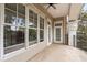 Private covered balcony featuring multiple windows and neutral decor at 5425 Closeburn Rd # 208, Charlotte, NC 28210