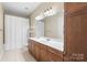 Bathroom with double vanity, wooden cabinets, and shower at 5425 Closeburn Rd # 208, Charlotte, NC 28210