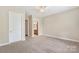 Spacious bedroom with carpet, neutral walls, and bathroom access at 5425 Closeburn Rd # 208, Charlotte, NC 28210