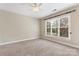 Carpeted bedroom with neutral walls and a large window at 5425 Closeburn Rd # 208, Charlotte, NC 28210