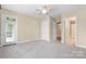 Well-lit bedroom featuring neutral walls, carpet, and access to ensuite at 5425 Closeburn Rd # 208, Charlotte, NC 28210