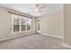 Large empty bedroom with neutral walls, carpet, and ceiling fan at 5425 Closeburn Rd # 208, Charlotte, NC 28210
