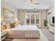 Well-lit bedroom with white accents, soft carpet, and a ceiling fan at 5425 Closeburn Rd # 208, Charlotte, NC 28210