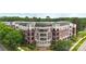 Beautiful brick condo building featuring private balconies and lush landscaping for a serene living experience at 5425 Closeburn Rd # 208, Charlotte, NC 28210