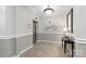 Well lit hallway with wainscoting, a mirror, an elevator, and tile flooring at 5425 Closeburn Rd # 208, Charlotte, NC 28210