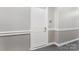 Neutral toned hallway with clean white trim leads to unit's entrance, providing privacy and refined access at 5425 Closeburn Rd # 208, Charlotte, NC 28210