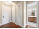 Well-lit hallway featuring hardwood floors, multiple entryways, and closet for easy access to other areas at 5425 Closeburn Rd # 208, Charlotte, NC 28210