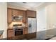 Close-up of kitchen with stainless appliances, granite countertops, and tile backsplash at 5425 Closeburn Rd # 208, Charlotte, NC 28210