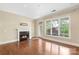 Bright living room featuring hardwood floors, fireplace, and large windows at 5425 Closeburn Rd # 208, Charlotte, NC 28210