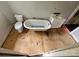 Bathroom featuring clawfoot tub, toilet, and vanity with wood-look flooring at 562 W Wilson Ave, Mooresville, NC 28115