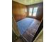 Bedroom with natural light, wood paneling, and mixed flooring at 562 W Wilson Ave, Mooresville, NC 28115