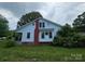Quaint home featuring a brick chimney and an open yard at 562 W Wilson Ave, Mooresville, NC 28115