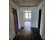 Hallway with dark wood floors and visible doorways to different rooms at 562 W Wilson Ave, Mooresville, NC 28115