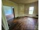 Spacious room with hardwood floors, natural light, and neutral paint at 562 W Wilson Ave, Mooresville, NC 28115
