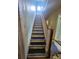 Traditional staircase with wooden railing and steps leading to the upper level at 562 W Wilson Ave, Mooresville, NC 28115