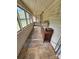 Sunroom with lots of windows, wood ceiling and floor, and a dresser with documents at 562 W Wilson Ave, Mooresville, NC 28115