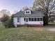 Rear exterior featuring a sunroom and spacious yard at 562 W Wilson Ave, Mooresville, NC 28115