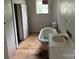 Modest bathroom features a classic tub, sink, and window providing natural light at 562 W Wilson Ave, Mooresville, NC 28115