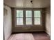 Bedroom features exposed flooring and three windows that provide plenty of natural light at 562 W Wilson Ave, Mooresville, NC 28115